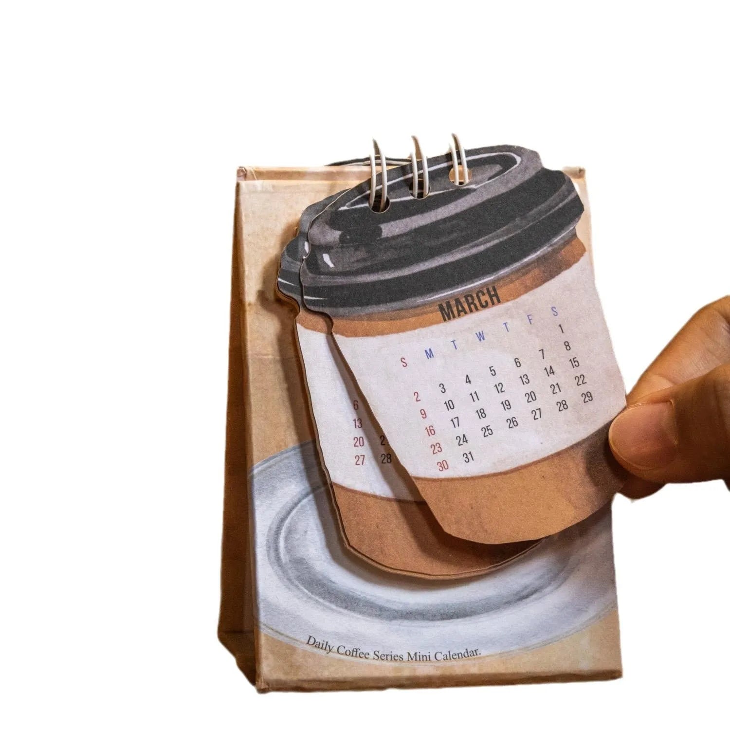Set of four different 2025 mini paper desk calendars with simple modern designs on a desk.