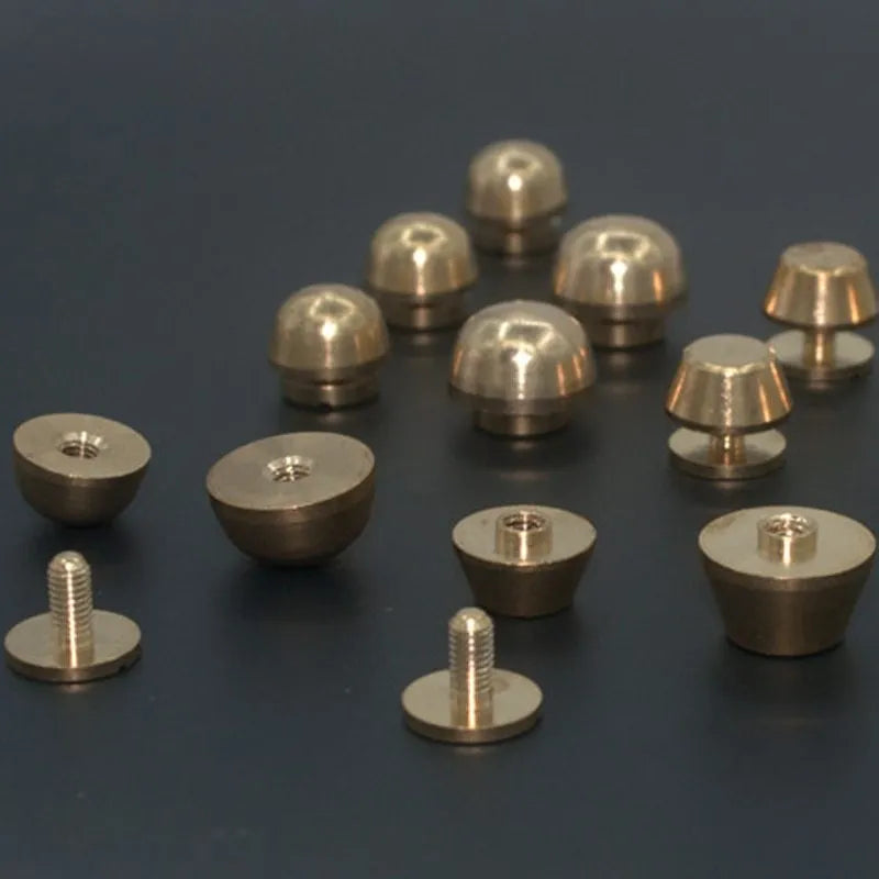 Solid brass decorative buckle for clothing in round and geometric foot nail designs.