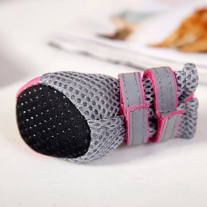 Teddy dog shoes in pink with diving fabric upper, reflective straps, and rubber sole on outdoor grass