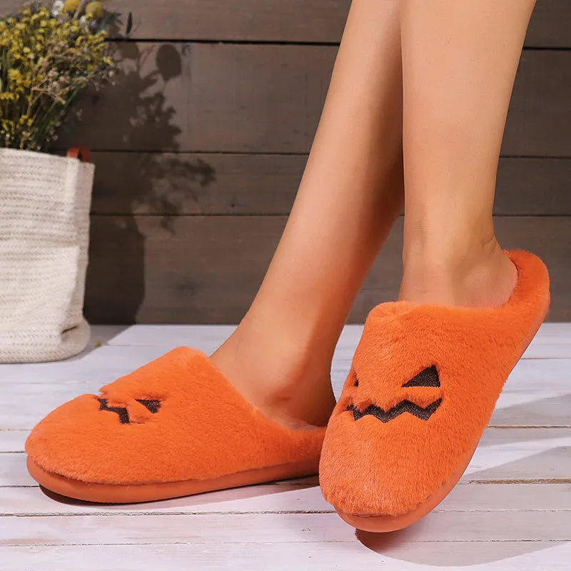 Orange Halloween pumpkin slippers with plush lining and textured PVC sole.