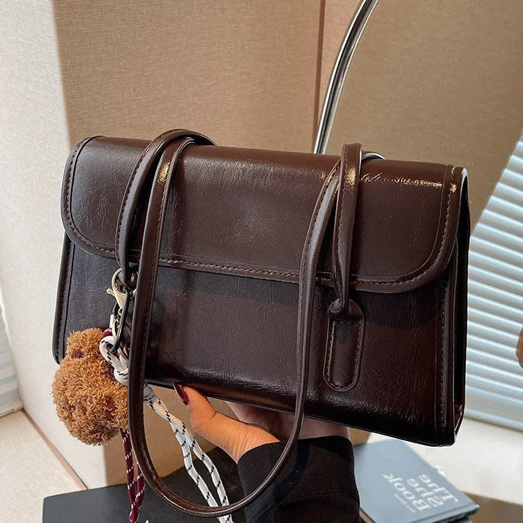 Brown women's PU Maillard handbag with pendant detail, horizontal square shape, and double shoulder straps
