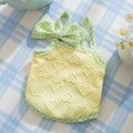 Small dog wearing blue vest with heart texture bow suspenders, elastic construction, casual pet clothing