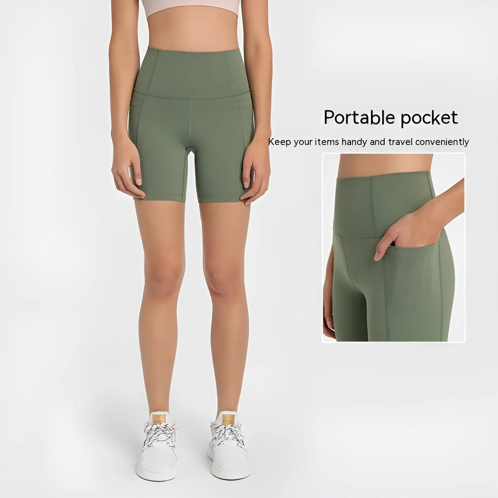 Women's tight-fit cotton blend sports shorts in light purple lotus colour, showing short fifth pants length.