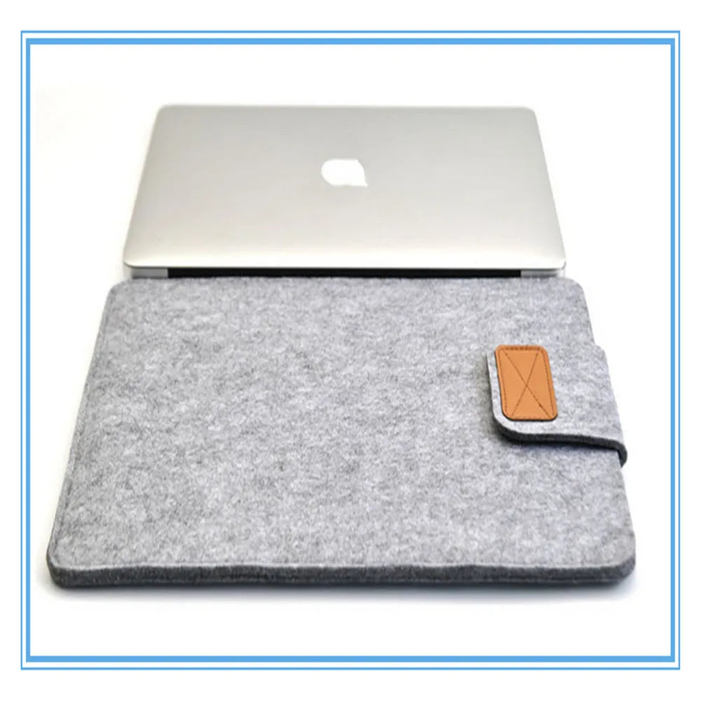 Dark grey clamshell laptop bag open to show plush woven interior lining for a tablet or notebook.