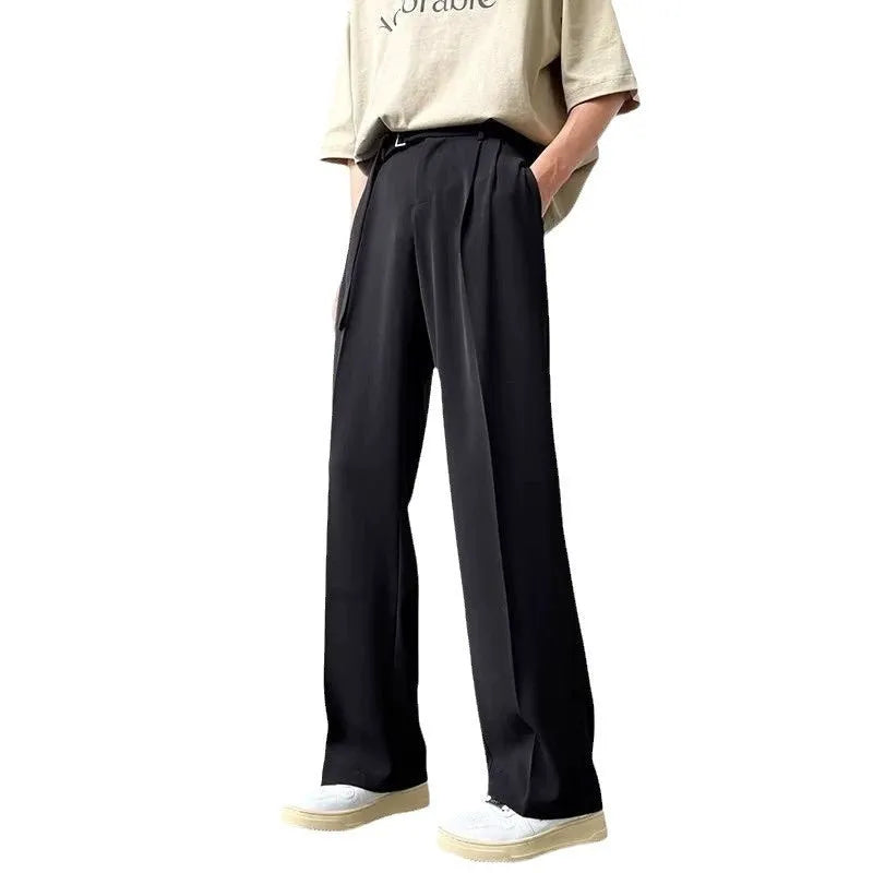 Black wide leg trousers with straight cut and non-iron finish laid flat