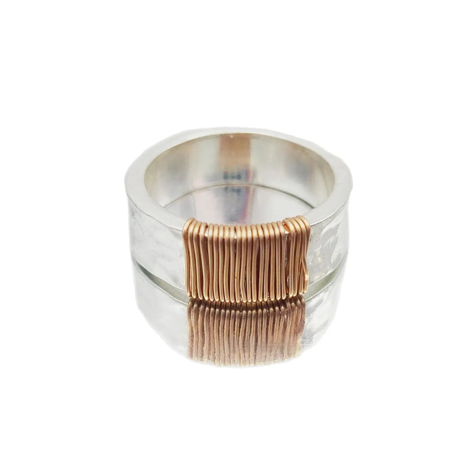 Copper bracelet ring with geometric coil design in silver gold colour on wrist