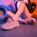 Women's white thick-soled sports shoes with woven upper, front strap, and rubber sole in multiple colour options
