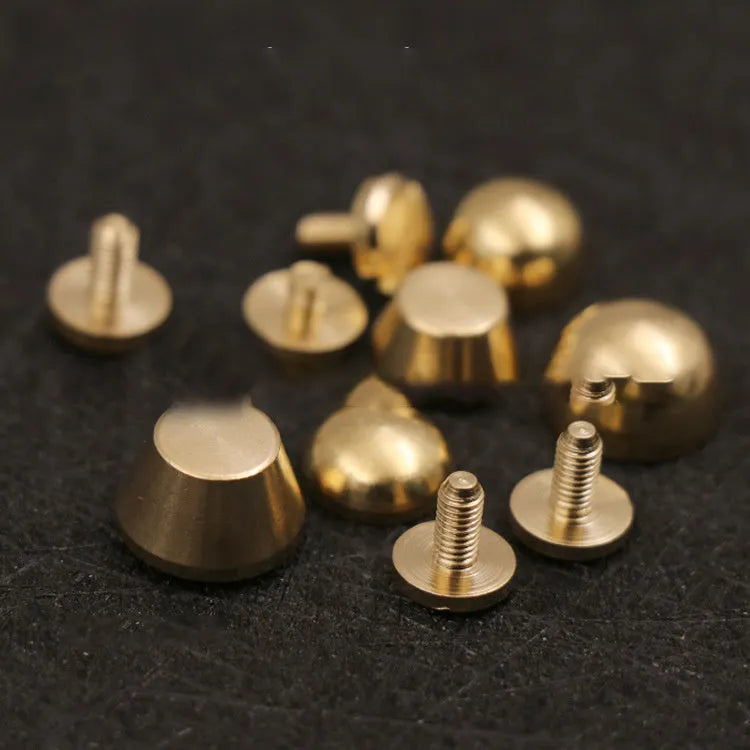 Solid brass decorative buckle for clothing in round and geometric foot nail designs.
