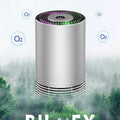 Compact black metallic car air purifier with USB cable on a car dashboard.