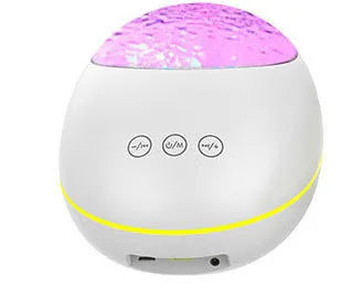 Black ocean wave projector LED night light with Bluetooth speaker and remote control on a table