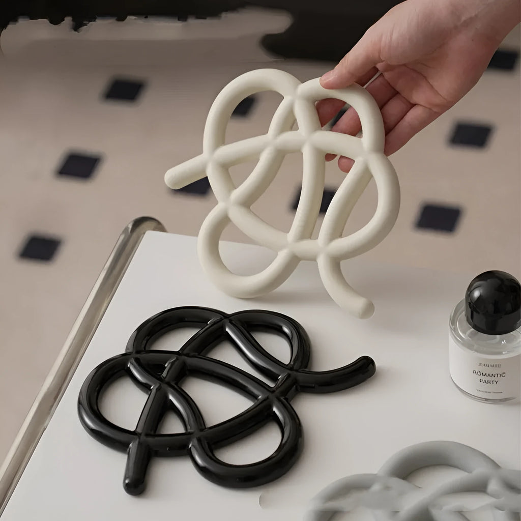 Ceramic heat proof mat with irregular organic shape in solid colour for dining table protection