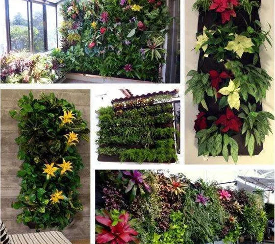 Vertical felt wall garden planting bag with multiple green pockets, hanging on an outdoor fence.