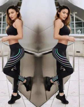 Woman wearing black glow-in-the-dark printed milk silk workout leggings for fitness.