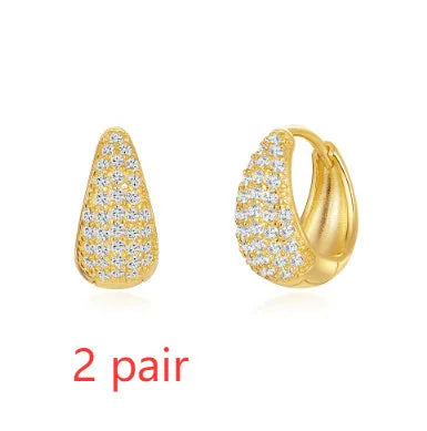 Golden geometric clip-on earrings with round design elements and electroplated finish