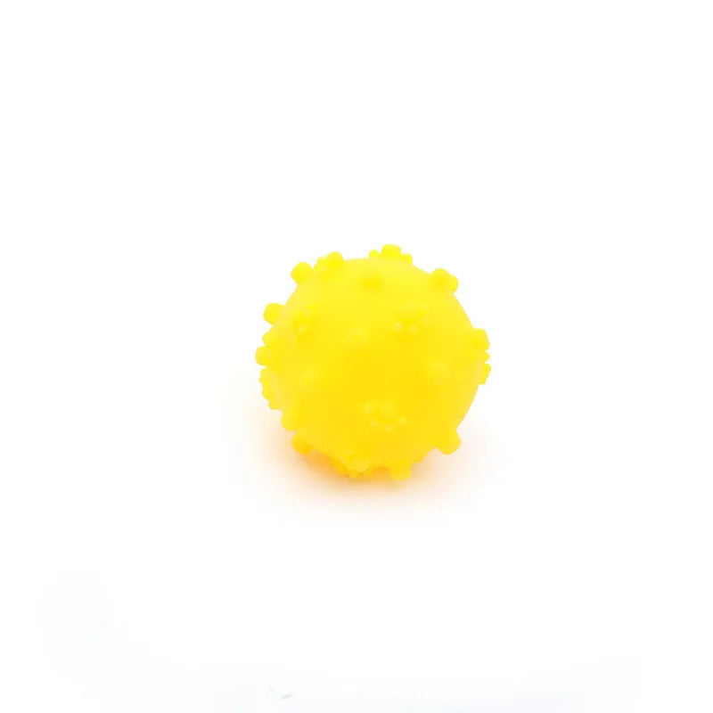A bright blue spiky dog toy ball with a dimpled texture, shown next to a measuring tape indicating its 2-inch diameter.
