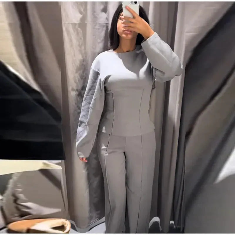 Women's polar fleece suit set showing O-neck pleated top with long sleeves and matching wide leg trousers