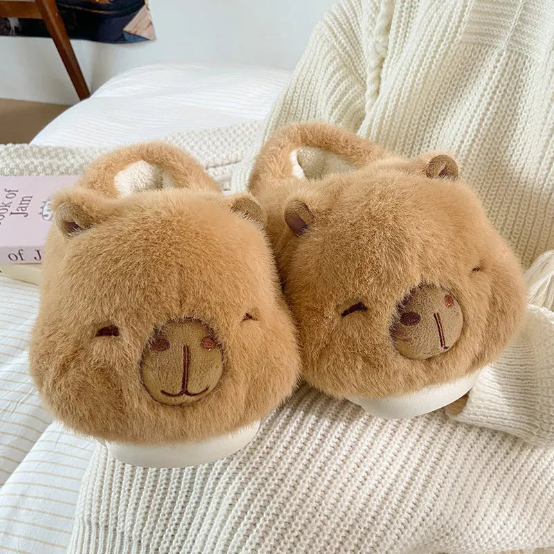 Light brown women's winter plush slippers with cartoon pattern and artificial wool lining.