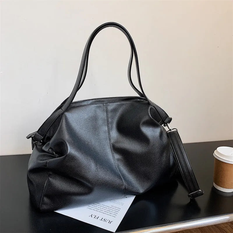 Soft surface large messenger tote bag in black with zipper opening and adjustable shoulder strap