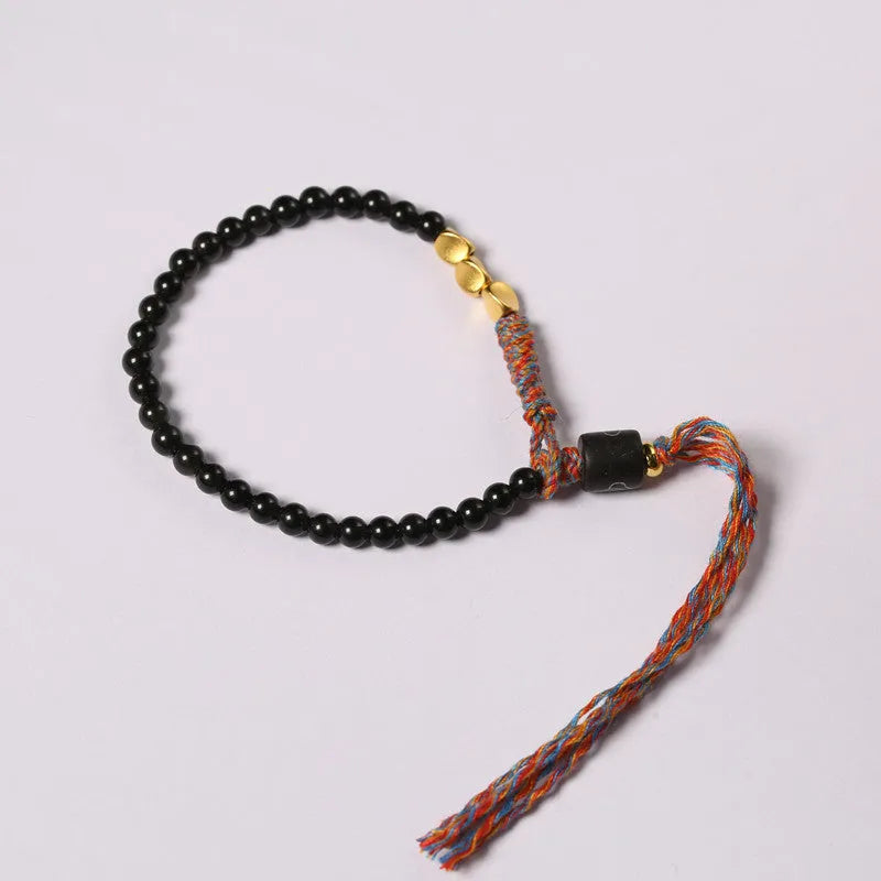 Hand-woven obsidian carrying strap bracelet showing textured surface and 4mm width detail