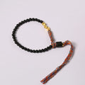 Hand-woven obsidian carrying strap bracelet showing textured surface and 4mm width detail