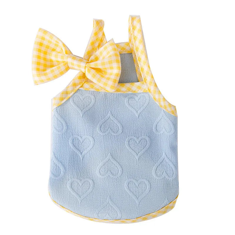 Small dog wearing blue vest with heart texture bow suspenders, elastic construction, casual pet clothing
