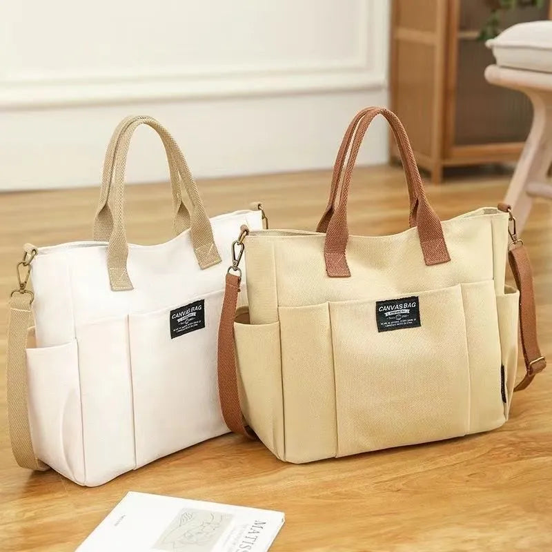Canvas shoulder bag in khaki, 31cm wide, with handle and crossbody strap, urban simplicity style