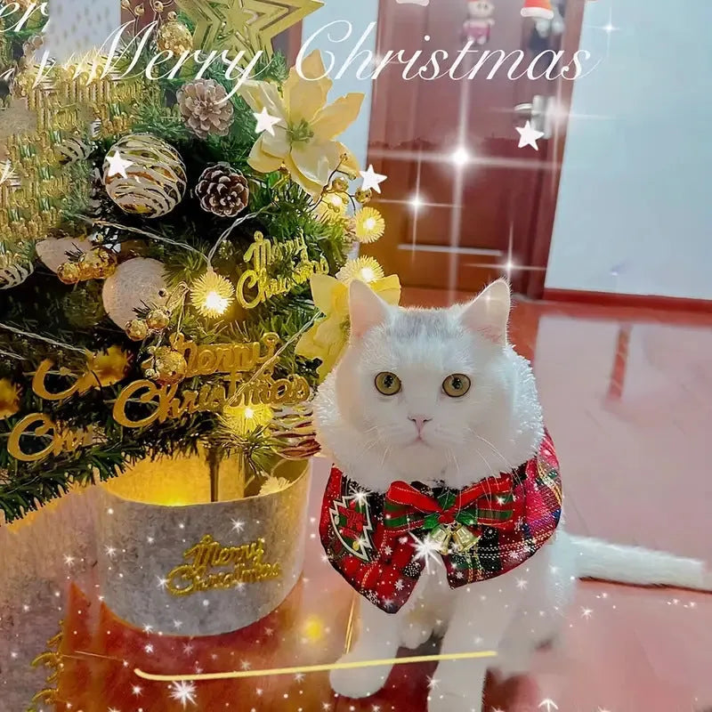 Red polyester pet scarf with white snowflake bell design wrapped around a dog's neck.