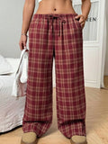 Women's loose fit plaid trousers with drawstring waist and patch pockets in casual styling