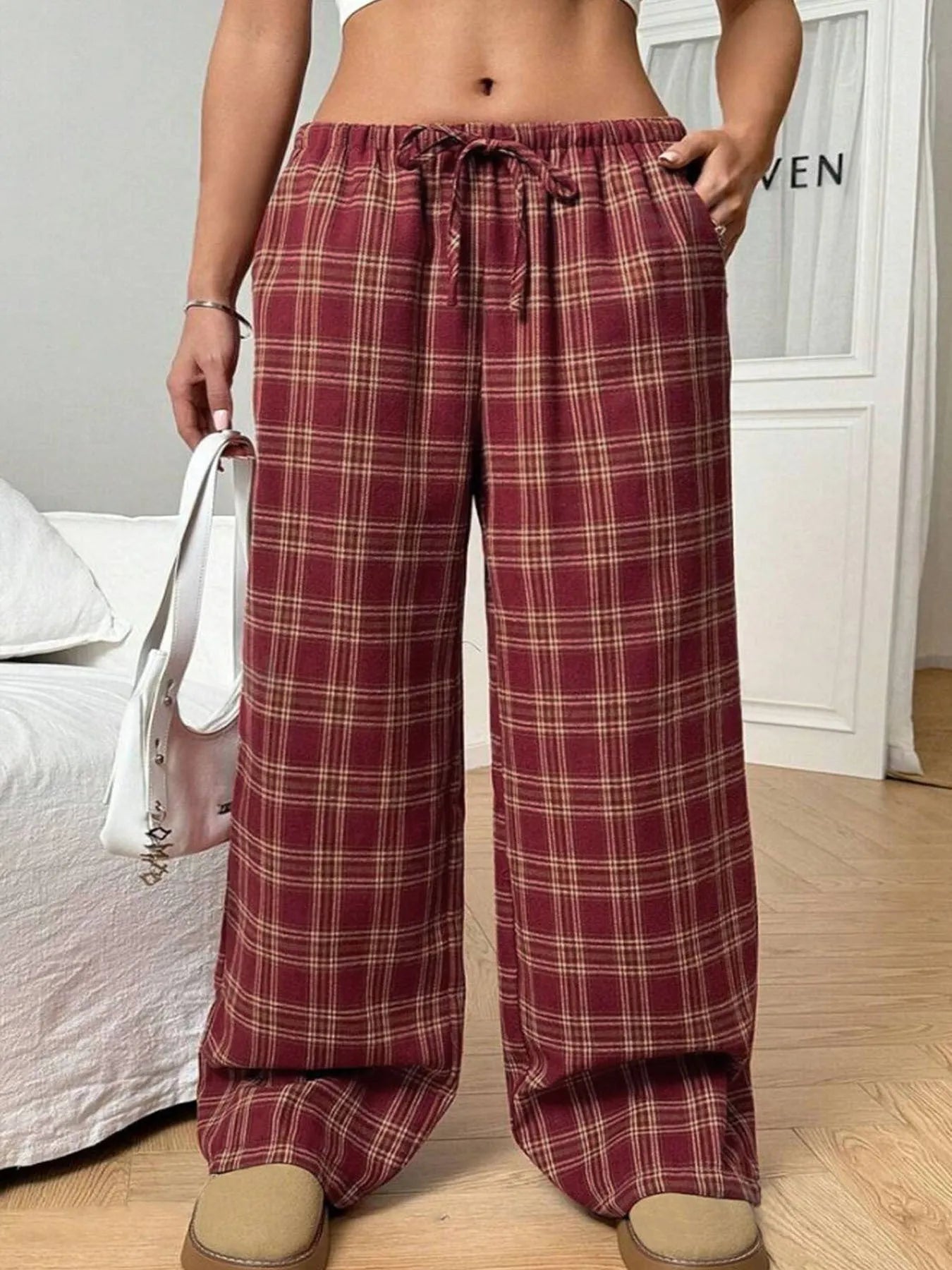 Women's loose fit plaid trousers with drawstring waist and patch pockets in casual styling