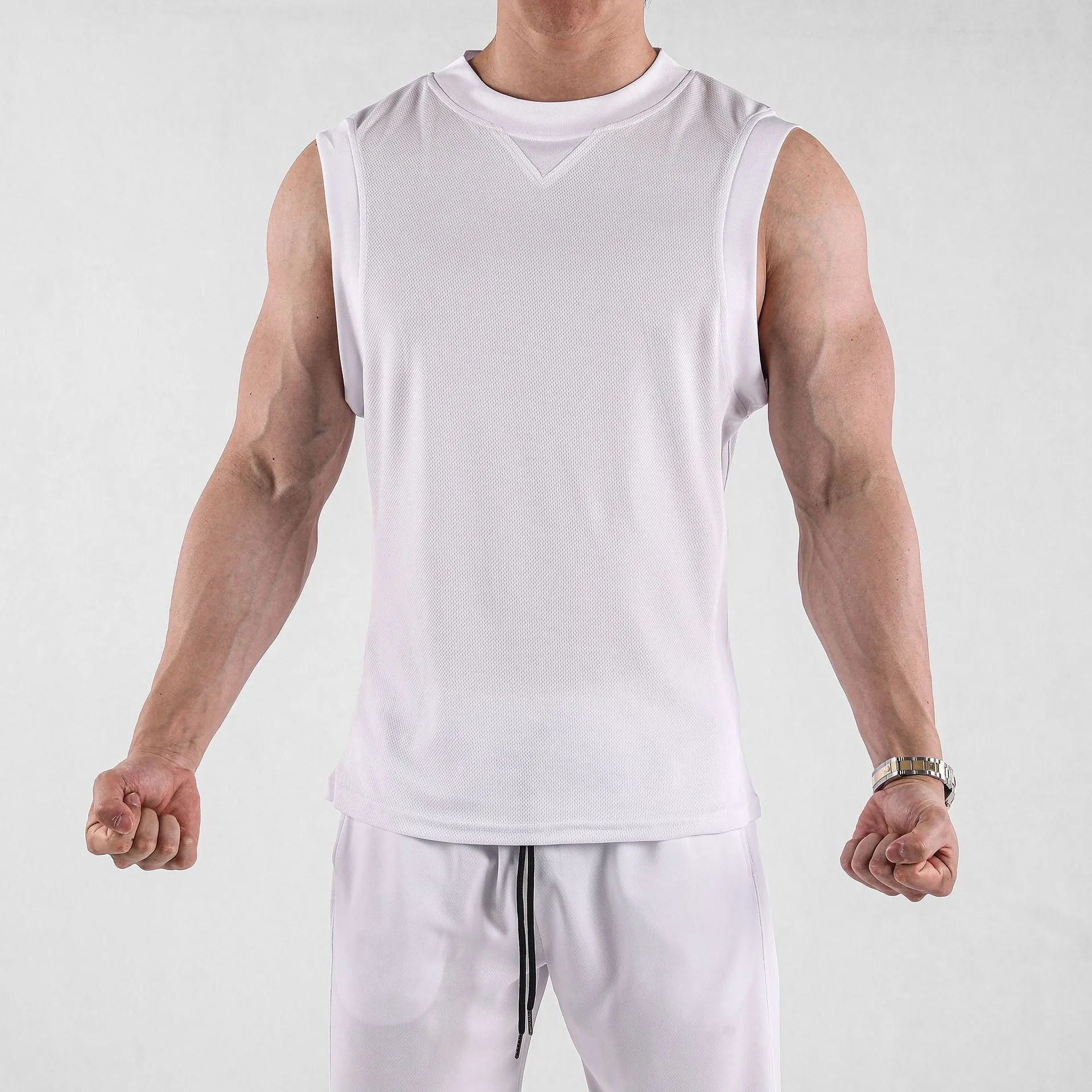 Men's loose-fitting white sports vest made from quick-dry polyester blend fabric.