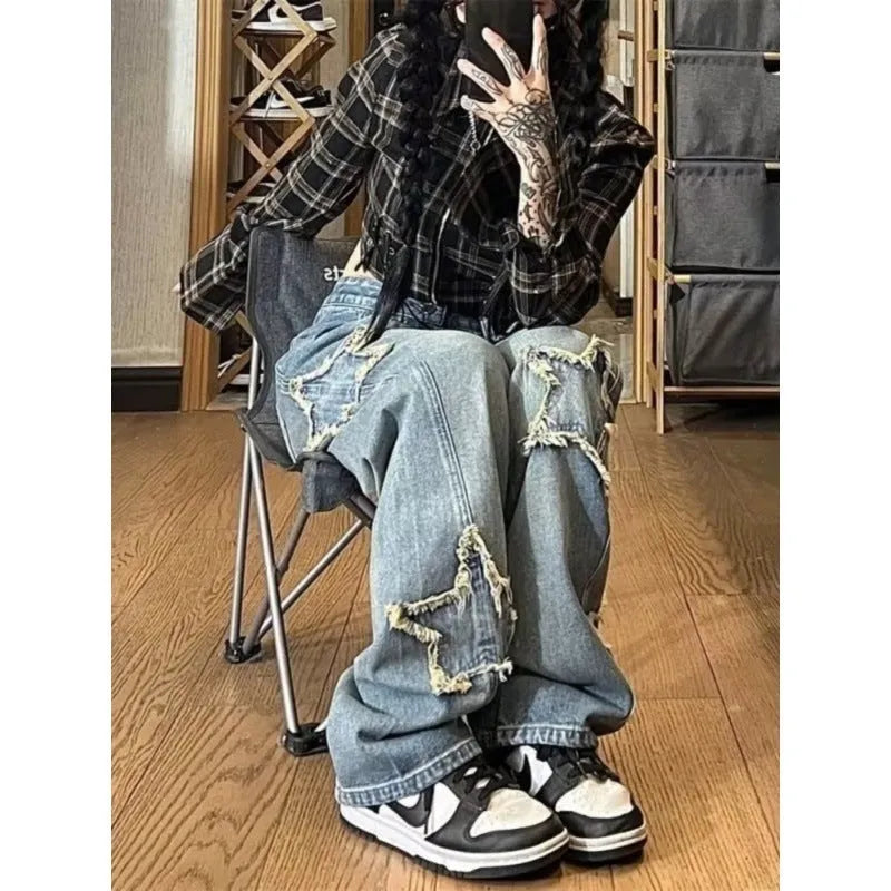 Blue high waist women's wide-leg denim trousers laid flat, showing straight leg cut and button fastening.