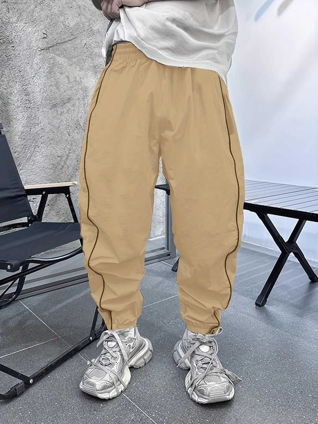 Man wearing loose-fit, cropped-length bamboo fibre sports trousers in Army Green colour.