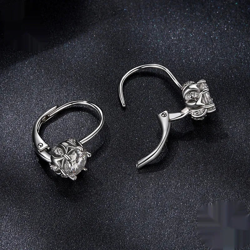 Silver flower bud shaped clip-on earrings with a white gold plated finish and a central moissanite stone.