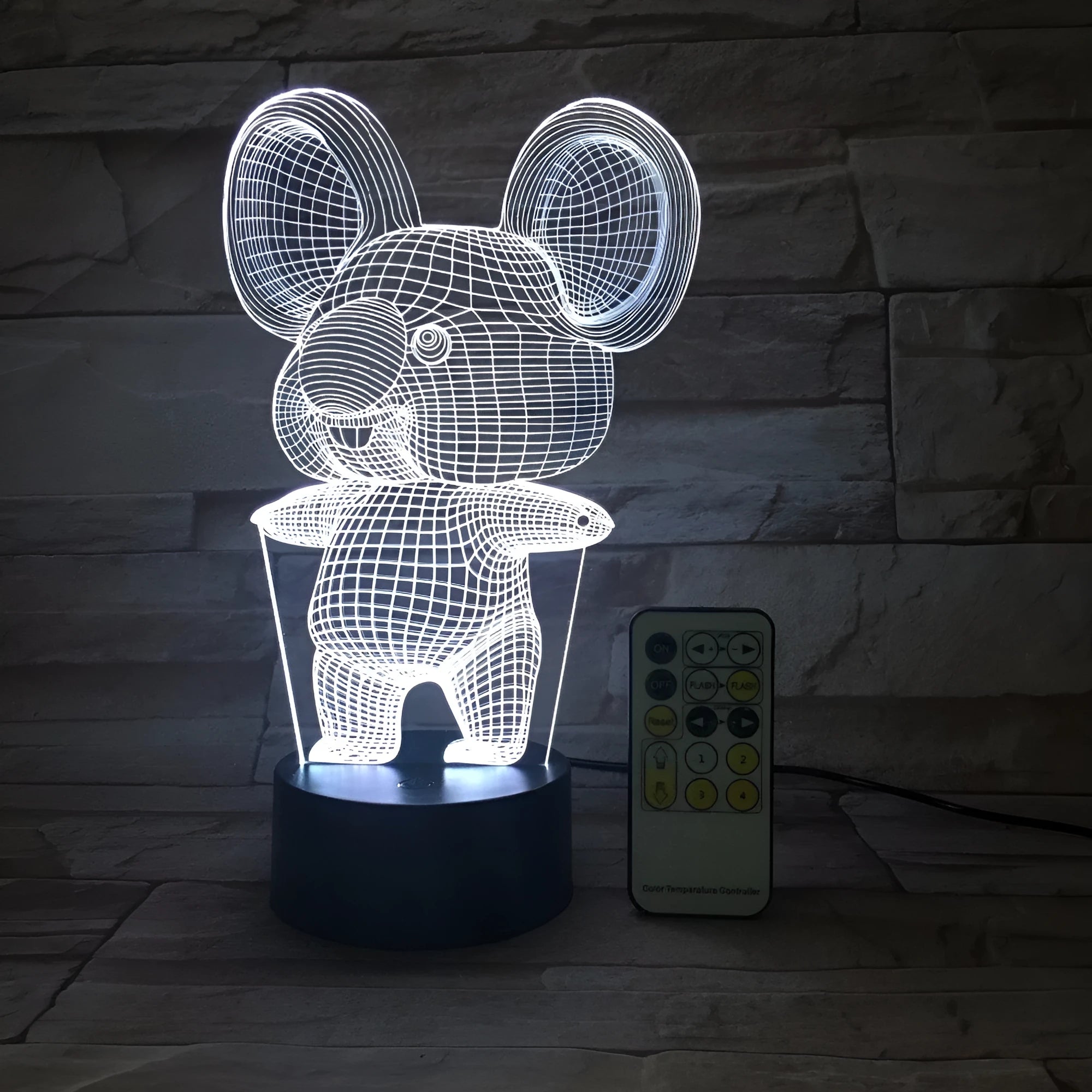 Black koala-shaped LED night light on a table showing multi-colour glow options including red, green, blue, and purple.
