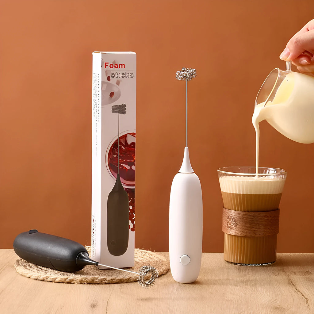 Black and white hand-held electric milk frother blender for coffee preparation