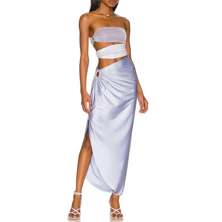 Purple one-piece swimsuit with a matching wrap skirt laid flat on a surface.