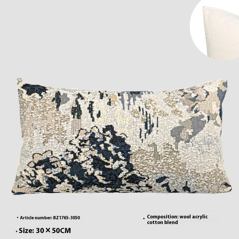 Antique blue abstract floral decorative pillow on a grey sofa, showing square and waist pillow sizes.
