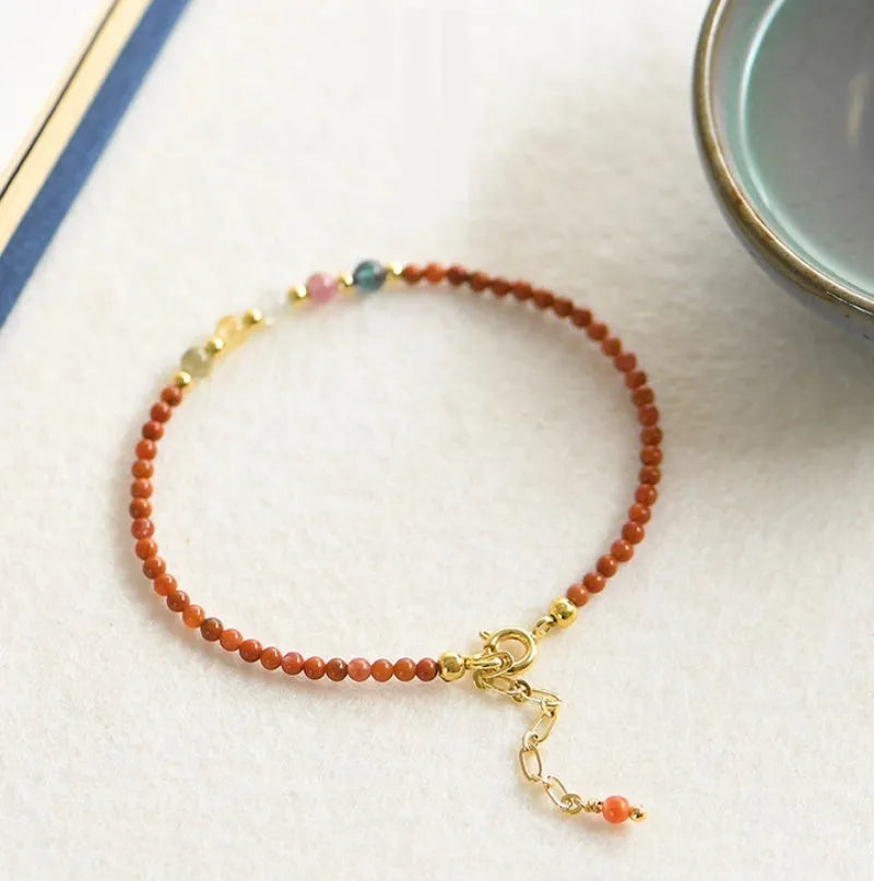 Women's freshwater pearl and crystal bracelet with geometric design on a simple braided or elastic rope band.