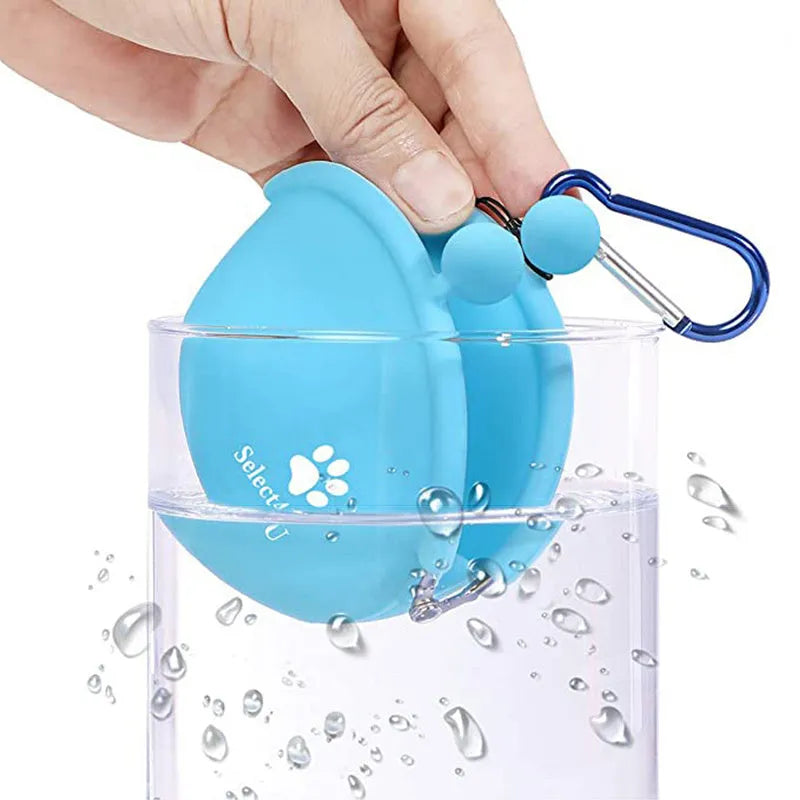 Yellow silicone dog training treat bag with hook-and-loop strap, shown attached to a waistband.
