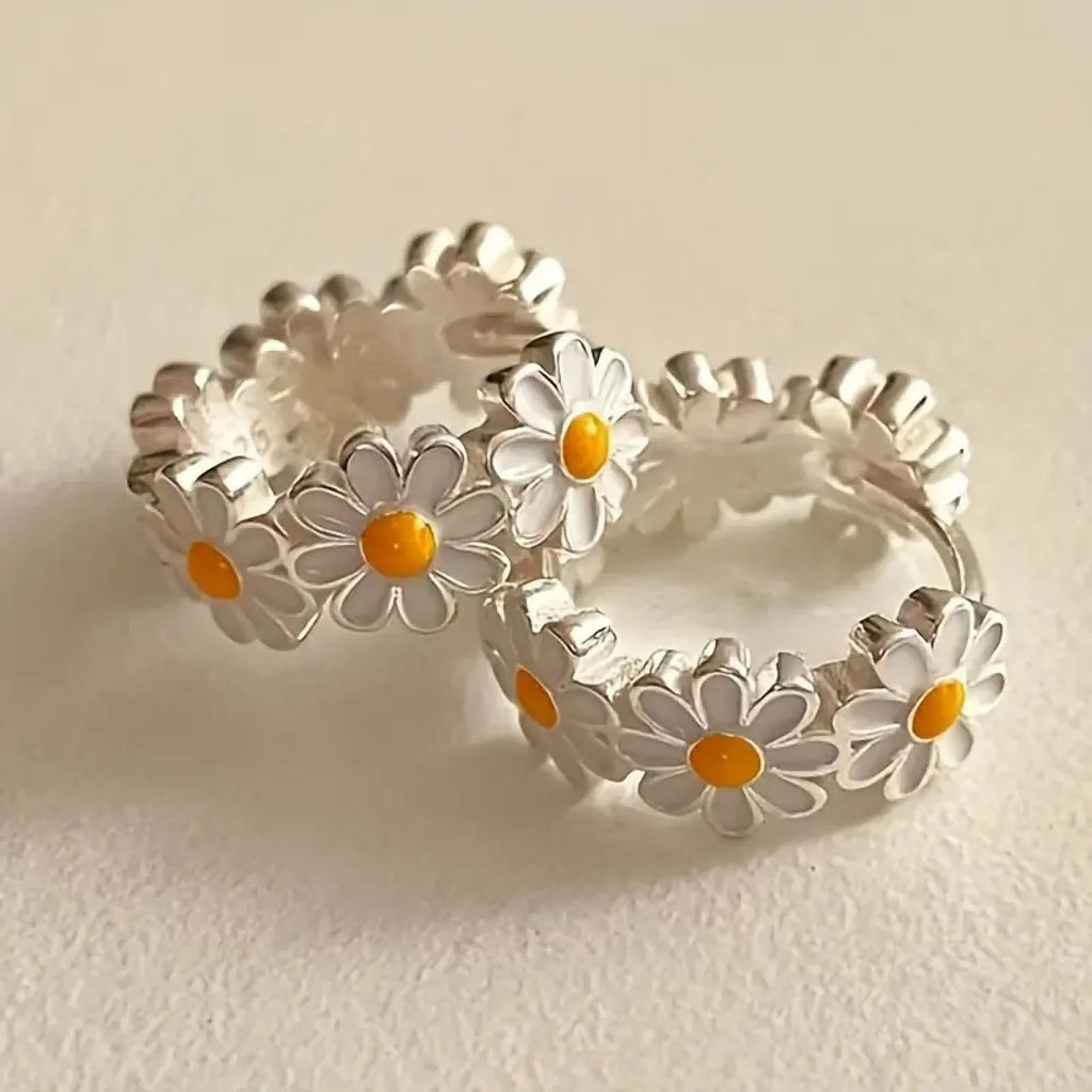 White daisy flower ring earrings with platinum gem inlay on a copper base.