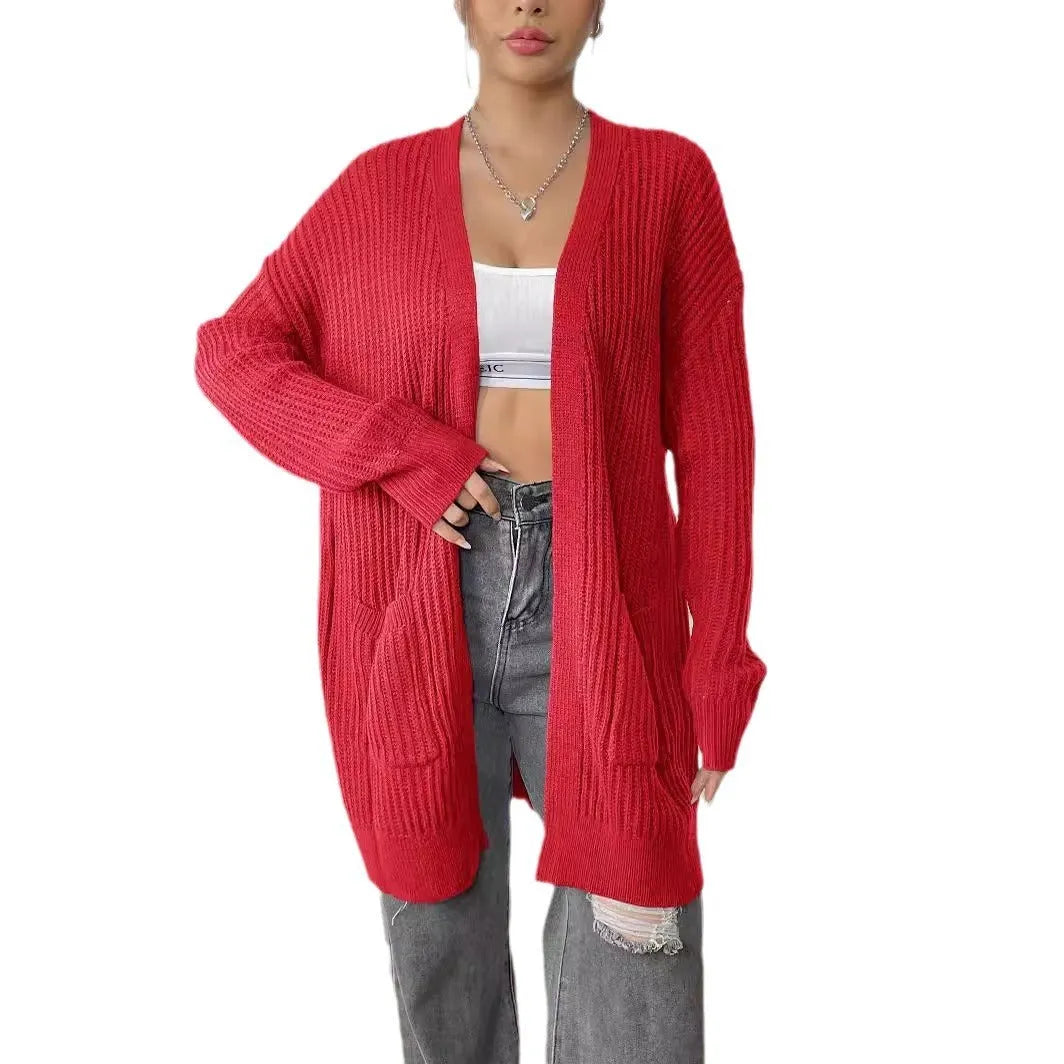 Women's dark green loose-fit cardigan sweater with two front pockets and long sleeves.