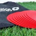 Soft yellow football training target pad, 23cm diameter flat disc on grass.