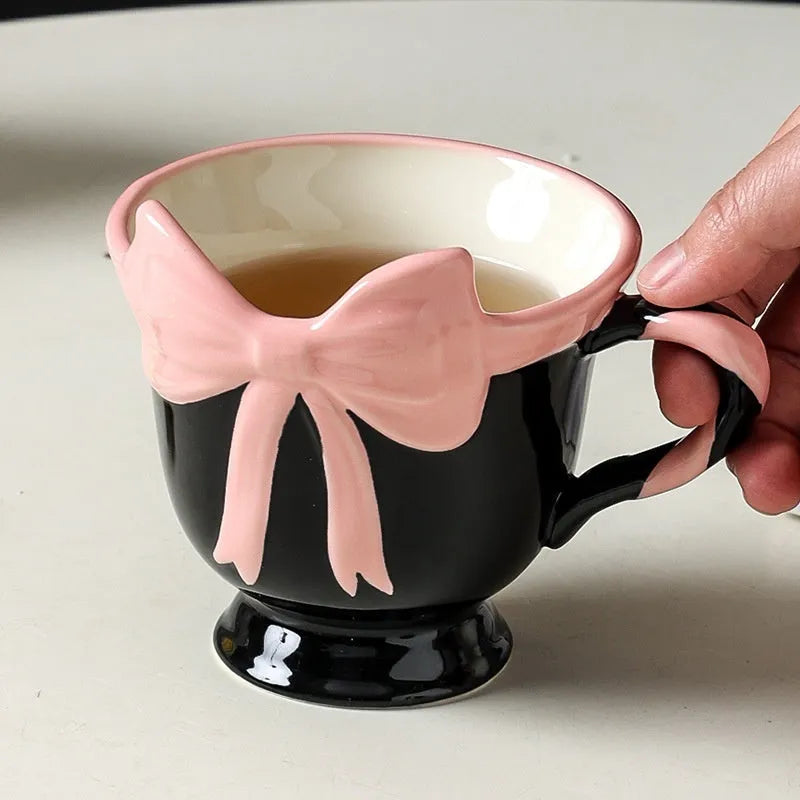 Heart-shaped ceramic mug with decorative bow design in white powder or black pink colour