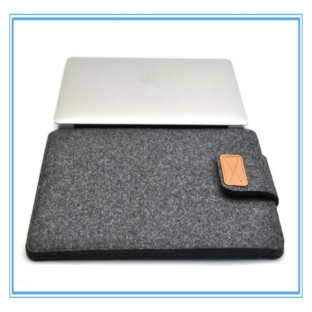 Dark grey clamshell laptop bag open to show plush woven interior lining for a tablet or notebook.