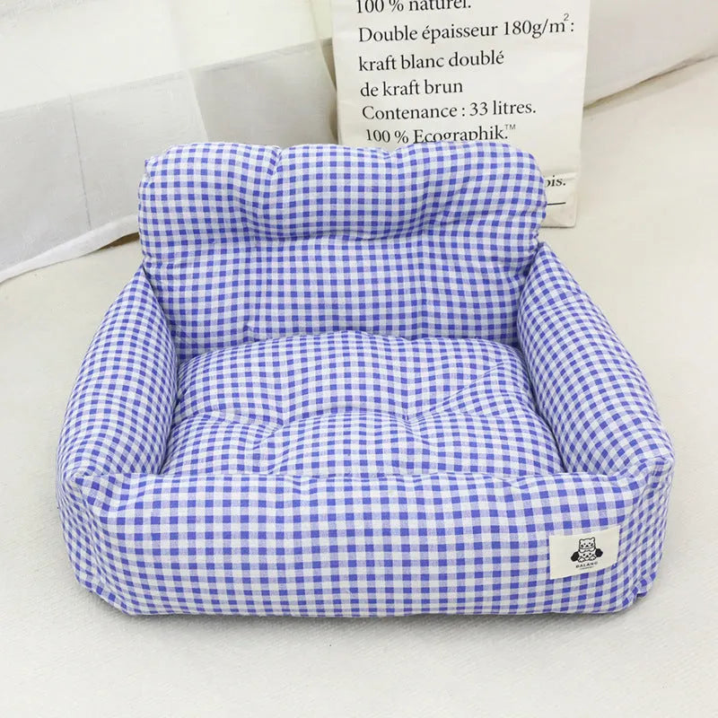 Car-mounted dog travel nest in stain-resistant cloth showing grey and blue plaid colour options