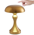 Bronze finish USB rechargeable desk lamp with touch control for three light colours on a wooden desk.