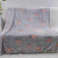 Cartoon-pattern flannel blanket laid flat, showing one of five colour options, suitable as a child's blanket or AC cover.