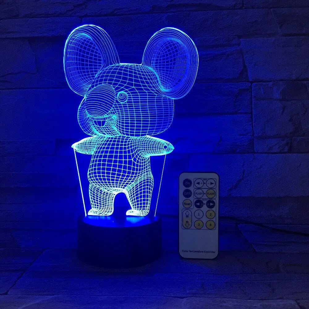Black koala-shaped LED night light on a table showing multi-colour glow options including red, green, blue, and purple.