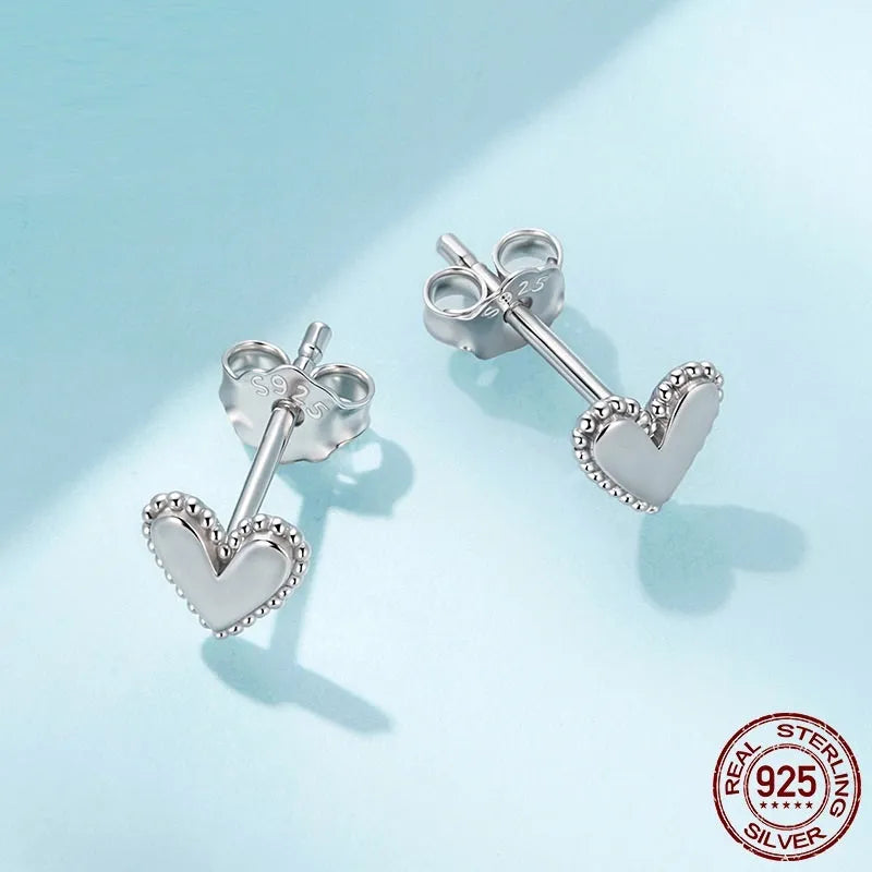 S925 sterling silver heart shaped stud earrings for women, electroplated finish, single pair on white background