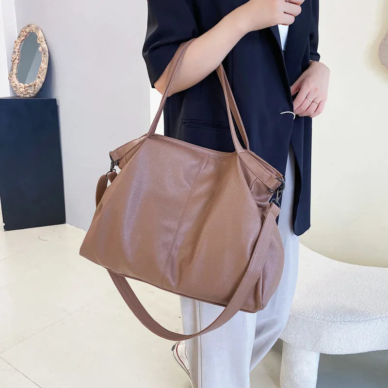 Soft surface large messenger tote bag in black with zipper opening and adjustable shoulder strap